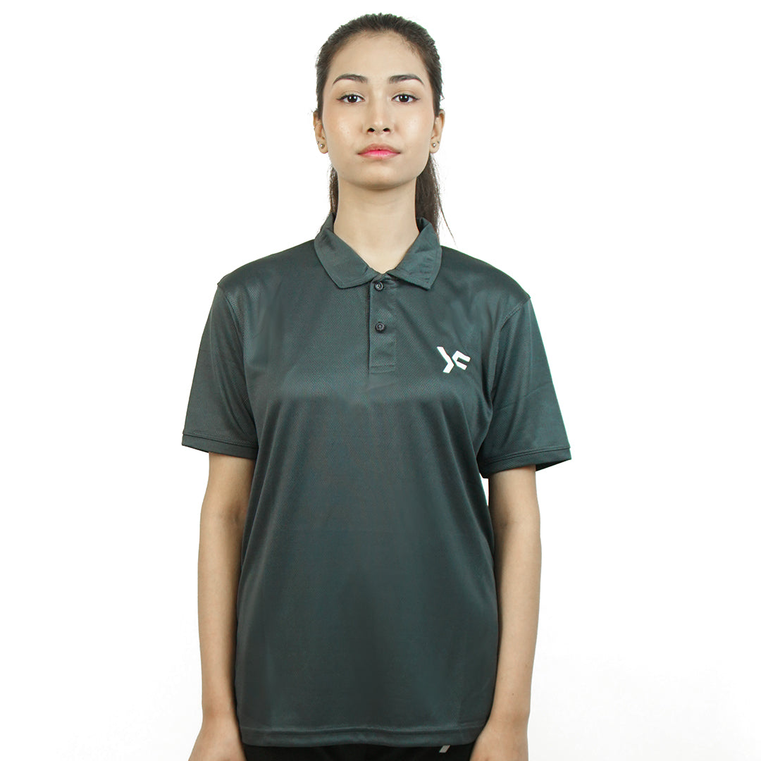 Person wearing a dark grey polo shirt for activewear, sports, or athleisure with a logo on a white background